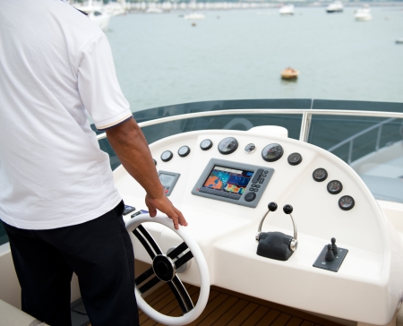 People at the helm of a luxury yacht.の写真素材