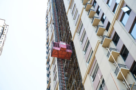 Construction hoist lifting a load at a construction site