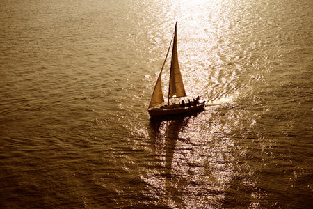 sailboat sailing sailing at the sea with a beautiful sunset.