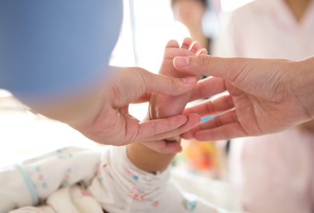 Masseur massaging little baby's foot.の写真素材