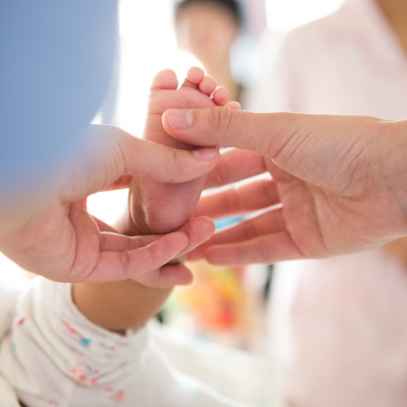 Masseur massaging little baby's foot.の写真素材
