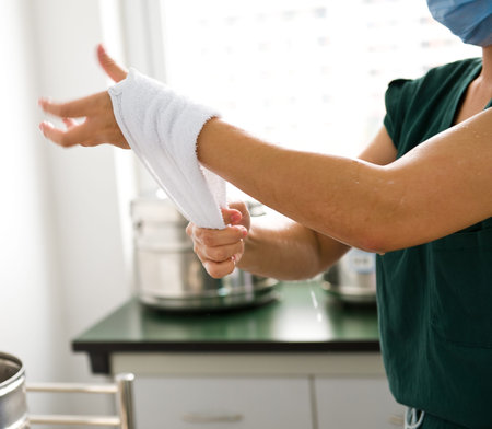 Female doctor washing hands before operation.の写真素材