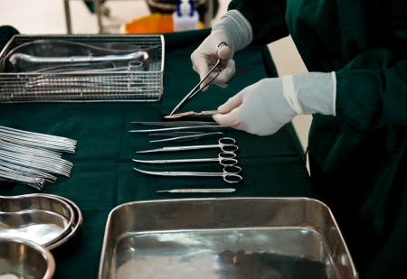 medical instruments with surgeons hand in operation roomの写真素材