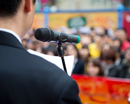 Business man is making a speech in front of crowds.の写真素材