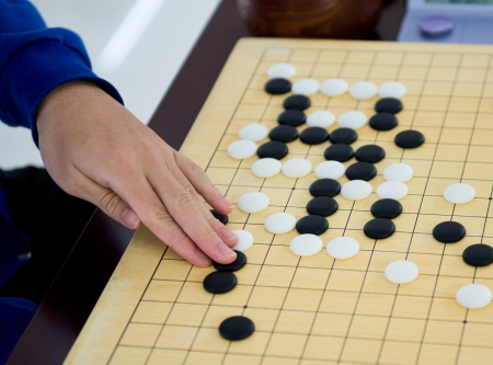 Detail of a woman playing chinese boardgame.の写真素材