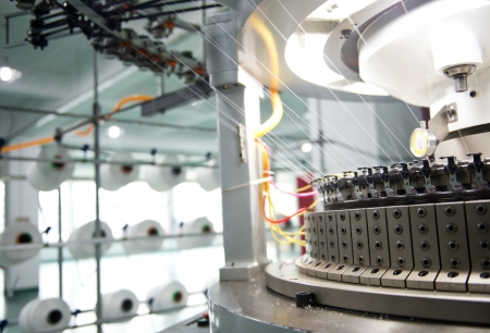 Textile industry - yarn spools on spinning machine in a textile factoryのeditorial素材