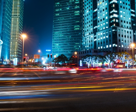 moving car with blur light through modern city at night.の写真素材