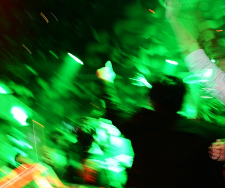 People raise up hands at nightclub.の写真素材