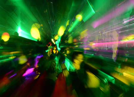 Dancing people in a disco, nightclub.