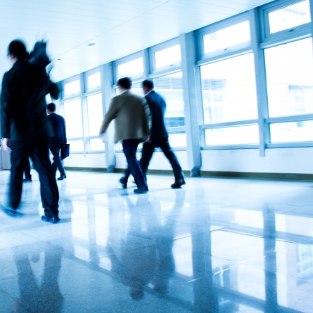 business people rushing in the lobby. motion blurの写真素材