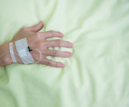 Close up of a iv drip in patient's hand.の写真素材