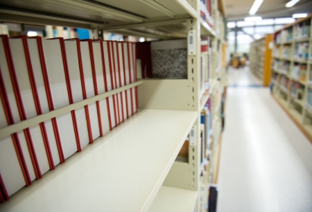 Interior of library with book shelves and books.の写真素材