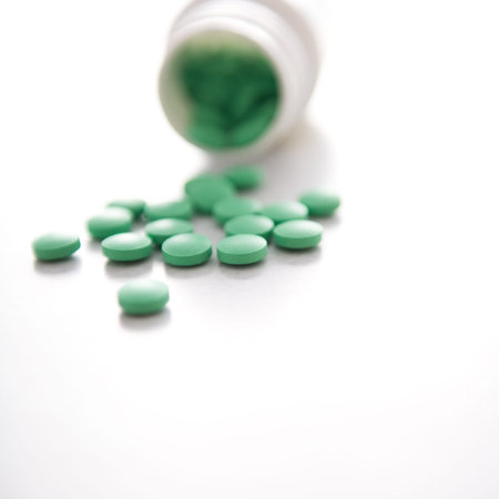 Many pills spilling out of pill bottle.の写真素材