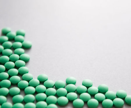 Many green pills isolated on table. の写真素材