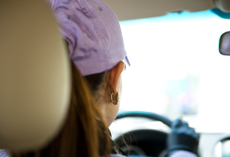 Female driver's hands on steering wheel inside of a carの写真素材