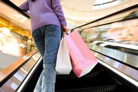 woman in shopping mall with bags.の写真素材