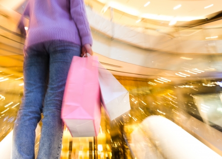woman in shopping mall with bags.の写真素材