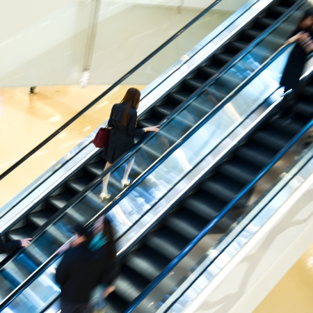 Business people walking on escalator.Blurred motionの写真素材