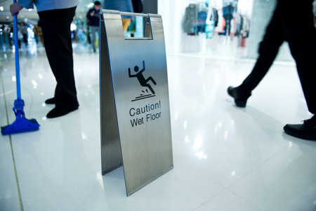 cleaning in progress, and wet floor caution sign besides.