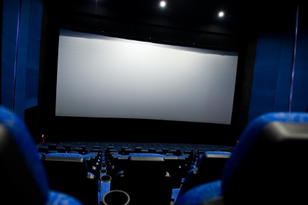Dark movie theatre interior. screen and chairs.のeditorial素材