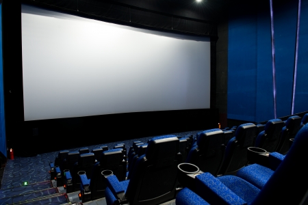 Dark movie theatre interior. screen and chairs.のeditorial素材