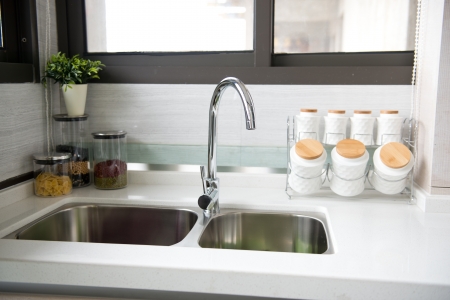 Interior of a modern kitchen with stanless steel double sink.の写真素材