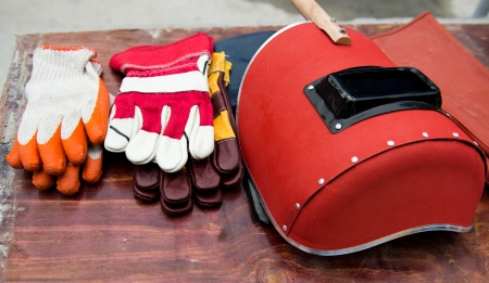 Welding mask and gloves on table.の写真素材