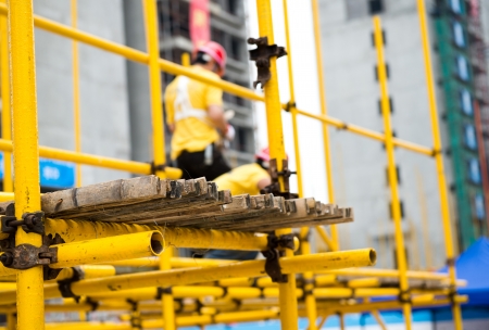 Construction workers working on scaffoldingの写真素材