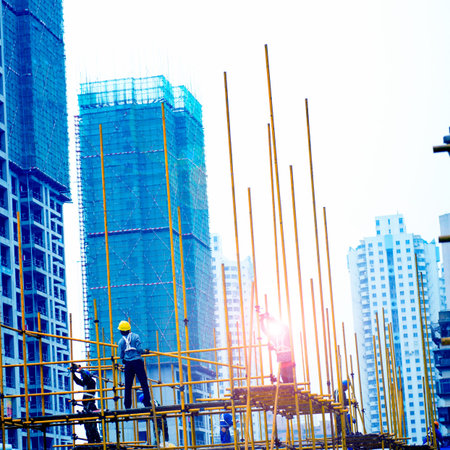 Construction workers working on scaffoldingの写真素材