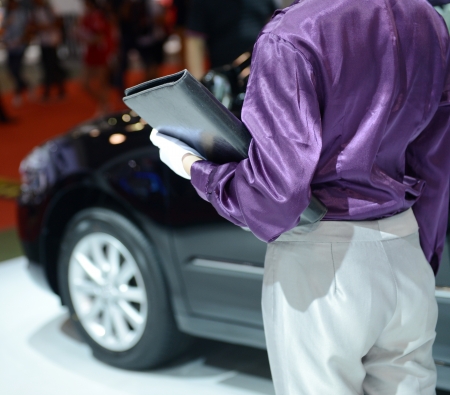 Car seller with car in a motor show.の写真素材