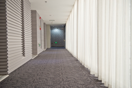 A long hotel corridor perspective with doors.のeditorial素材