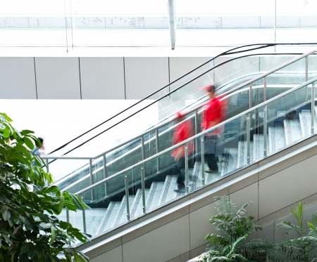 People rush on escalator motion blurred.の写真素材