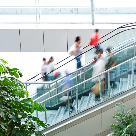 People rush on escalator motion blurred.の写真素材