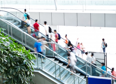 People rush on escalator motion blurred.の写真素材