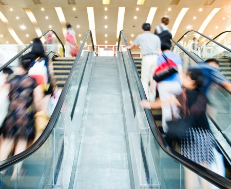 People rush on escalator motion blurred.の写真素材