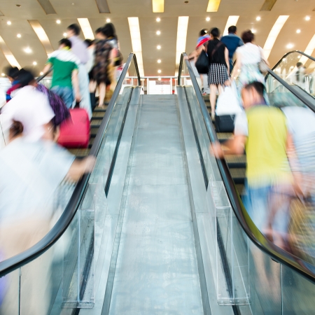 People rush on escalator motion blurred.の写真素材