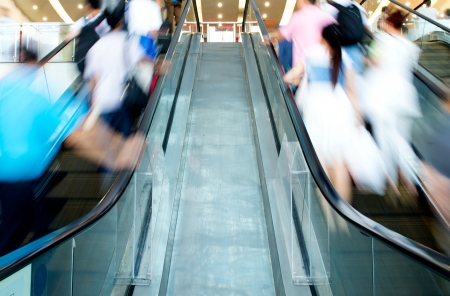 People rush on escalator motion blurred.の写真素材