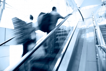People rush on escalator motion blurred.の写真素材