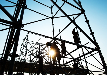 Construction workers working on scaffoldingの写真素材