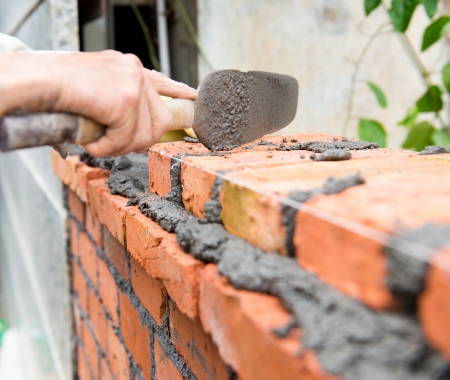 builder laying bricks in site.の写真素材