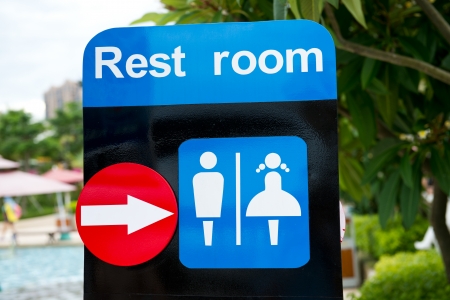 Toilet sign with direction on a board.の写真素材