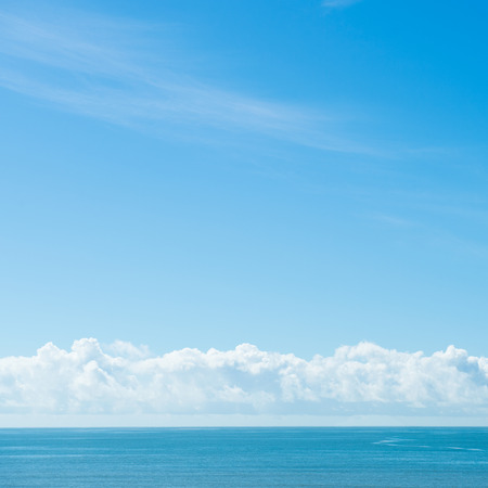 Blue sea with white clouds for background.の写真素材