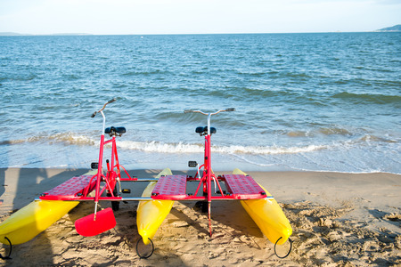 Plastic water bikes parked on the beachの写真素材