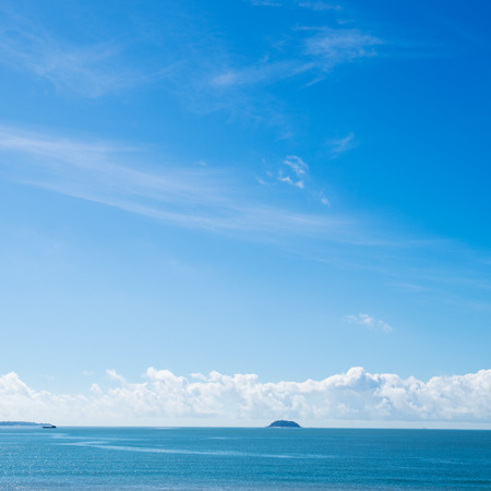 Blue sea with white clouds for background.の写真素材