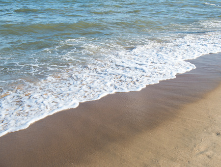 wave of the sea on the sandy beachの写真素材