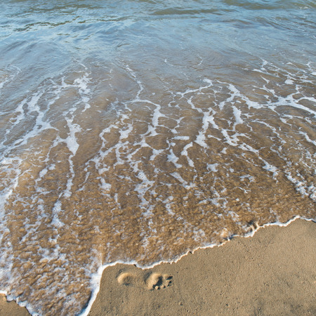 wave of the sea on the sandy beachの写真素材