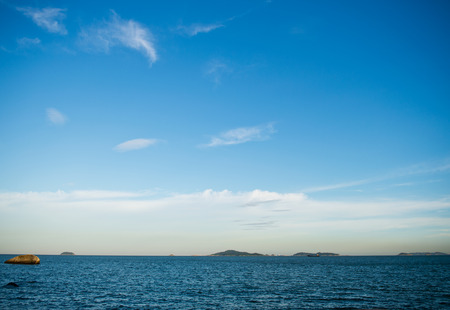 Blue sea with white clouds for background.の写真素材