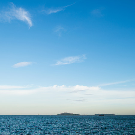 Blue sea with white clouds for background.の写真素材