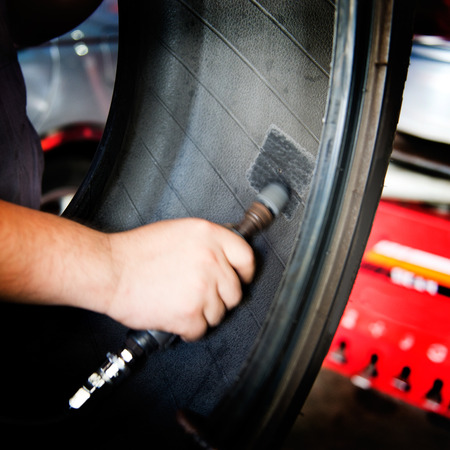 Mechanic making a patch on the rubber.の写真素材