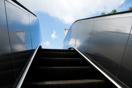 Wide angled view to perspective escalators stairway with background of blue sky.の写真素材